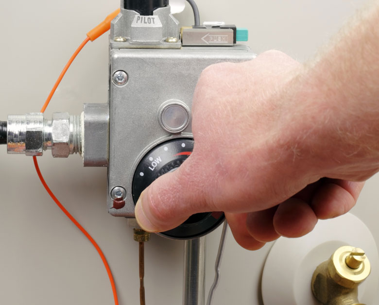 Living Water - Hot Water Tank Repair Kelowna - Man Adjusting Heat
